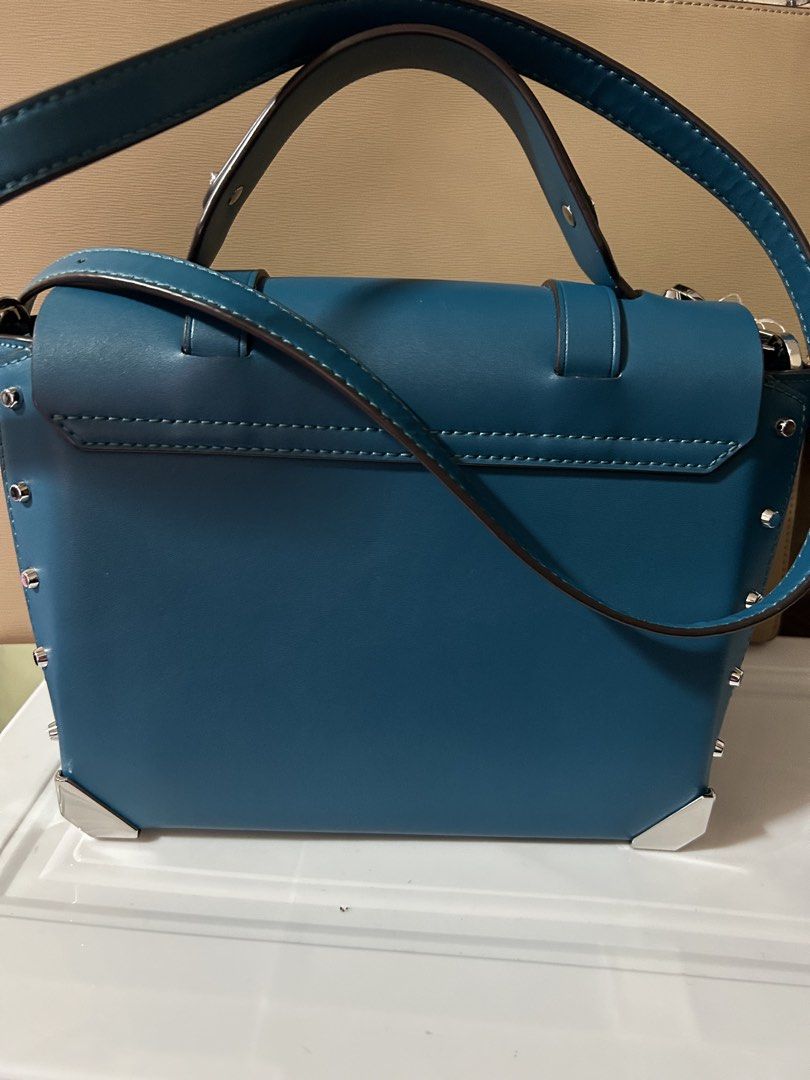 Michael Kors Manhattan Satchel Bag (Category: Luxury Bags & Wallets) located in Manila. Submitted by dragon.lady1 (Listing ID 1445815241, Image 3). Description: - Authentic Michael Kors Manhattan Satchel - Color: Teal. Excellent condition - Silver hardware and all-over stud details - Top handle or adjustable crossbody strap - Secure front flap with a lock closure - Interior includes a zip pocket and fabric lining .