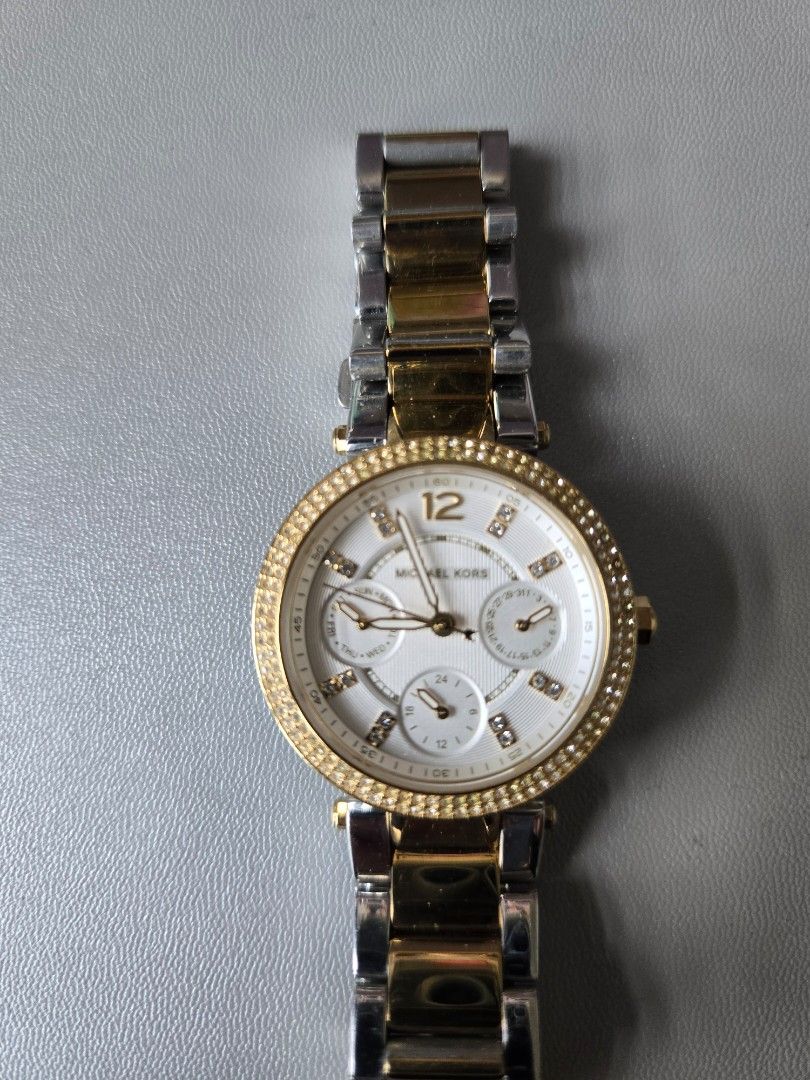 Michael Kors Two-Tone Chronograph Watch (Category: Luxury Watches) located in Quezon City. Submitted by mgdeclutters (Listing ID 1445849063, Image 2). Description: - Michael Kors Two-Tone Watch (Gold & Silver Stainless Steel) - White Dial with Chronograph Functions - Bezel encrusted with small stones - Water Resistant up to 10 ATM - Secure Clasp - Versatile for everyday or dressy wear.