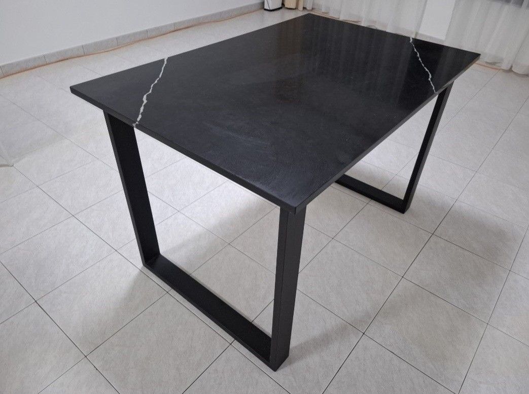 Solid marble Black Dining Table (Category: Tables & Sets) located in Singapore. Submitted by aipha (Listing ID 1445983655, Image 2). Description: - 120cm by 80cm. 2 units - Sleek black marble dining table - Tabletop with subtle white marble-like veining - Sturdy black metal legs for an industrial look - Comfortably seats 4-6 people - Versatile for dining rooms or as a workspace.