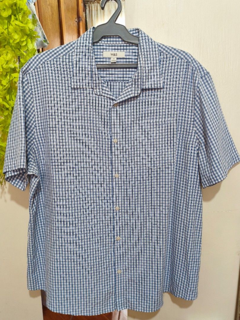 [M&S] Marks & Spencer Men's Short Sleeve Gingham Button-Down Shirt (Category: Tshirts & Polo Shirts ) located in Bontoc. Submitted by rad.bunny (Listing ID 1444226383, Image 1). Description: Authentic Marks & Spencer (M&S) Short Sleeve Button-Up Shirt •Design: Classic blue & white gingham check pattern with a left-chest patch pocket. •Style: Smart-casual, perfect for casual outings, office wear, or summer styling. 📐FLAT LAID🫟 W-64cm L-75cm ❌not