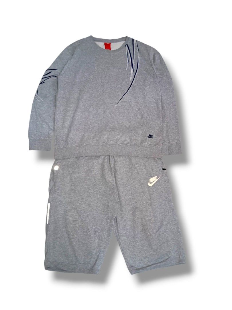 Nike Grey Sweatshirt & Shorts Set - Size 2XL (Category: Activewear) located in Rizal. Submitted by thriftbycho (Listing ID 1445806717, Image 1). Description: - Grey Nike sweatshirt and shorts set - Size: 2XL - Sweatshirt features unique blue and white graphic details on sleeve and chest - Shorts have a small Nike logo - Ideal for casual wear or workouts - Nike overall - Nike sweatshirt - Nike sweatshort - Nike grey set.