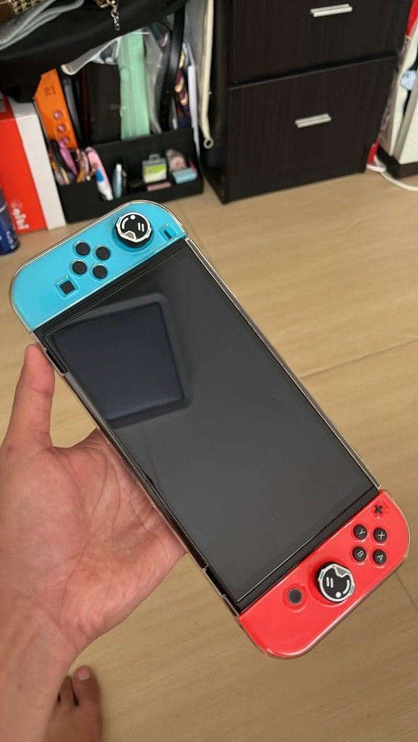 Nintendo Switch Oled (Category: Nintendo) located in Taguig. Submitted by phoopa (Listing ID 1445845794, Image 2). Description: - Nintendo Switch Console - Original Box - Good as New - Dock - Joy-Cons - Charging Grip - Dying light - Travel Case - Acrylic Case - Mario-themed Carrying Case - NBA 2K26 Game - Extra Light Blue Controller - 6 months old - Already have Youtube - All items shown in my posts kasama yan sa package Last price posted..