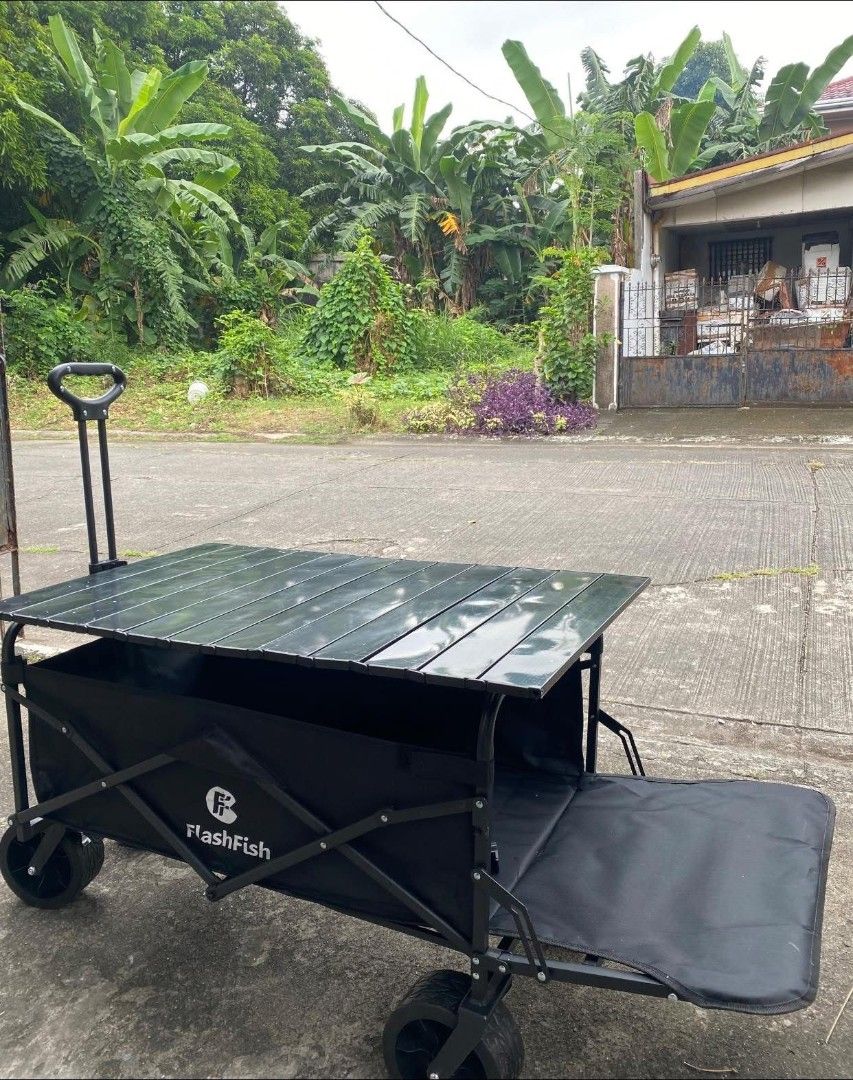 Open rear type Camping Wagon with Tabletop (Category: Hiking & Camping) located in Manila. Submitted by shairatorres (Listing ID 1445824915, Image 3). Description: - FlashFish Folding Wagon in Black - Versatile: Ideal for camping, beach trips, picnics, or hauling gear - Removable Tabletop: Doubles as a convenient table - Easy Storage: Folds compactly for effortless transport and storage - Durable Wheels: Built for sturdy and reliable use - Includ