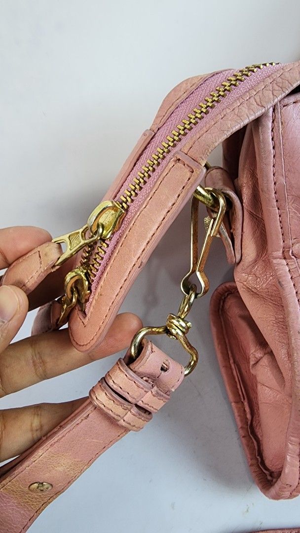 Pink Leather Handbag with Gold Hardware (Category: Luxury Bags & Wallets) located in Baguio. Submitted by chiechie1234 (Listing ID 1445834676, Image 2). Description: - Stylish pink leather handbag - Features a comfortable top handle - Includes a detachable shoulder strap for versatility - Elegant gold hardware accents - Zippers are in good working condition - Shows some signs of wear on leather and hardware, adding character - Ideal for everyday 