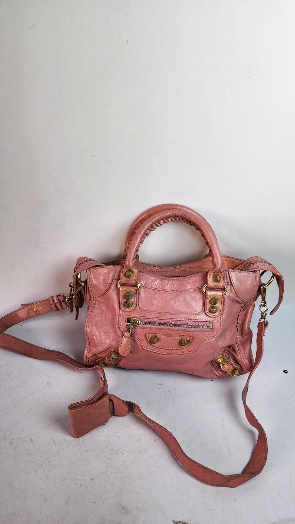 Pink Leather Handbag with Gold Hardware (Category: Luxury Bags & Wallets) located in Baguio. Submitted by chiechie1234 (Listing ID 1445834676, Image 1). Description: - Stylish pink leather handbag - Features a comfortable top handle - Includes a detachable shoulder strap for versatility - Elegant gold hardware accents - Zippers are in good working condition - Shows some signs of wear on leather and hardware, adding character - Ideal for everyday 