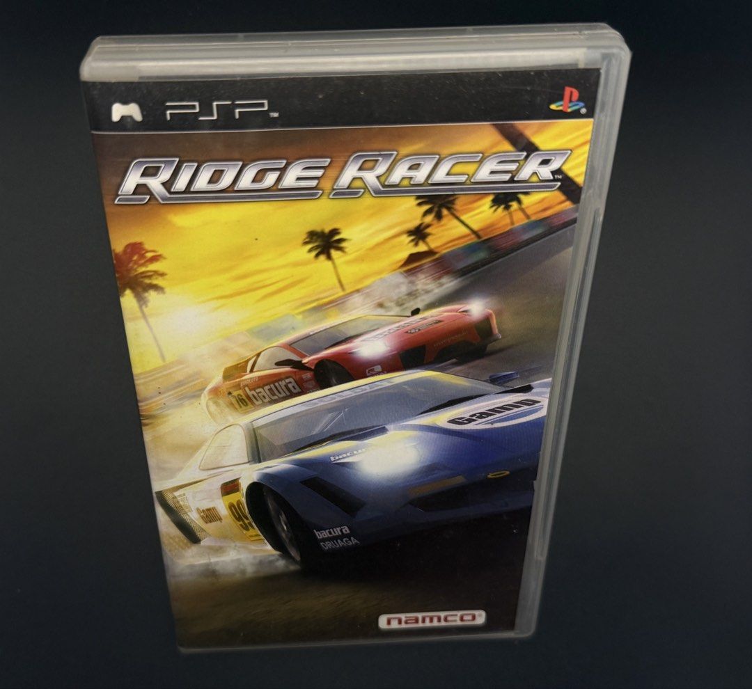 PSP Ridge Racer UMD Game (Category: PlayStation) located in Las Pinas. Submitted by cjdmc (Listing ID 1445856847, Image 1). Description: - Ridge Racer for PSP - Includes UMD disc and original case - Classic, fast-paced racing action - Features cool cars - Perfect for PSP owners seeking a retro racing experience.