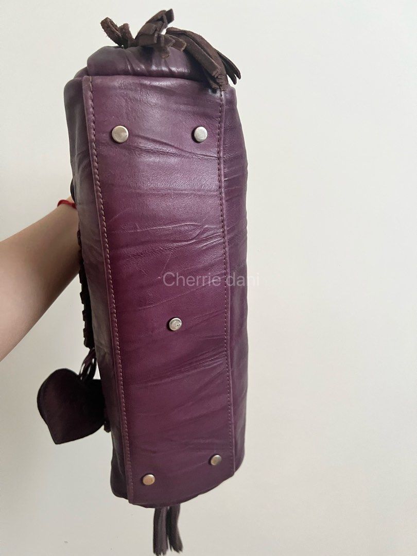 Roberta Gandolfi Purple Leather Handbag (Category: Luxury Bags & Wallets) located in Manila. Submitted by cherrie_dani (Listing ID 1445660996, Image 3). Description: LAST PRICE POSTED - Eye-catching purple leather handbag - Unique stitching details for a distinctive look - Adorable heart charm with 'RG' logo - Trendy side tassels and handle tassel detail - Ample interior space for all your essentials - Ideal for everyday use and stylish outings.