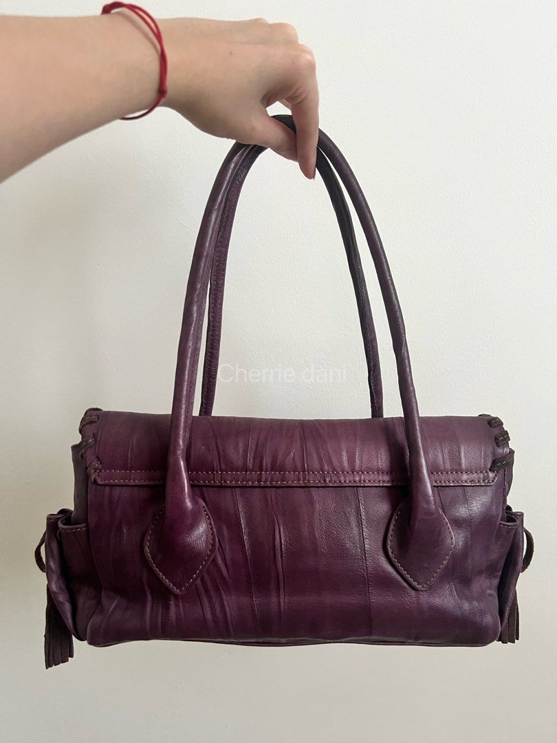 Roberta Gandolfi Purple Leather Handbag (Category: Luxury Bags & Wallets) located in Manila. Submitted by cherrie_dani (Listing ID 1445660996, Image 2). Description: LAST PRICE POSTED - Eye-catching purple leather handbag - Unique stitching details for a distinctive look - Adorable heart charm with 'RG' logo - Trendy side tassels and handle tassel detail - Ample interior space for all your essentials - Ideal for everyday use and stylish outings.