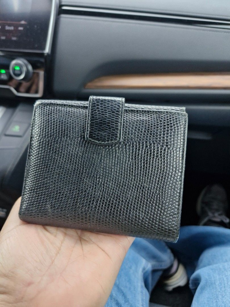 Salvatore Ferragamo Black Lizard Leather Wallet (Category: Luxury Bags & Wallets) located in Las Pinas. Submitted by jmproperties (Listing ID 1445939087, Image 2). Description: - Authentic Salvatore Ferragamo wallet - Made from luxurious black lizard leather - Iconic Gancini buckle with ribbon detail - Compact bifold design - Multiple card slots for organization - Includes a convenient coin pouch - Shows some signs of wear on the ribbon and edges