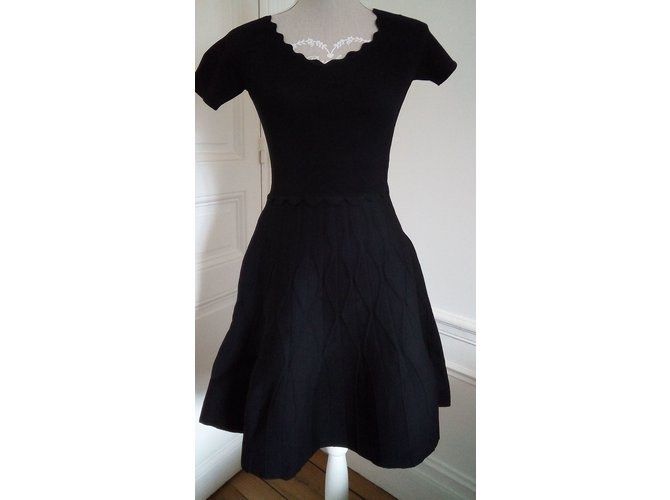 Sandro Dress Black Viscose (Category: Dresses) located in Manila. Submitted by tvrfinds (Listing ID 1445973422, Image 2). Description: Black knit dress with short sleeves. Features a scalloped neckline and hem. The skirt has a textured pattern. Great for dressing up or down. Authentic Good as new condition .