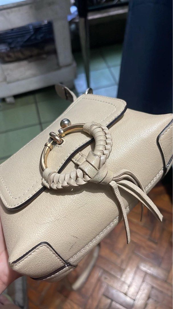 See by Chloé Hana (Category: Luxury Bags & Wallets) located in Quezon City. Submitted by retann (Listing ID 1438634679, Image 2). Description: - Cream-colored See by Chloé Hana shoulder bag - Circular ring detail with braided leather - Long, adjustable strap for crossbody wear - Flap closure - Minimalist design - Ideal for everyday use.