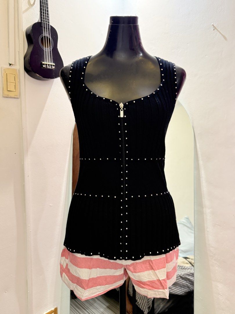 Sleeveless Ribbed Top with Studs and Zipper (Category: Sleeveless) located in Caloocan City. Submitted by prettyplease000 (Listing ID 1445929649, Image 3). Description: - Black ribbed sleeveless top - Zipper down the front - Stud details on neckline, zipper, and waist - Fitted silhouette - Versatile: great for layering or wearing on its own.