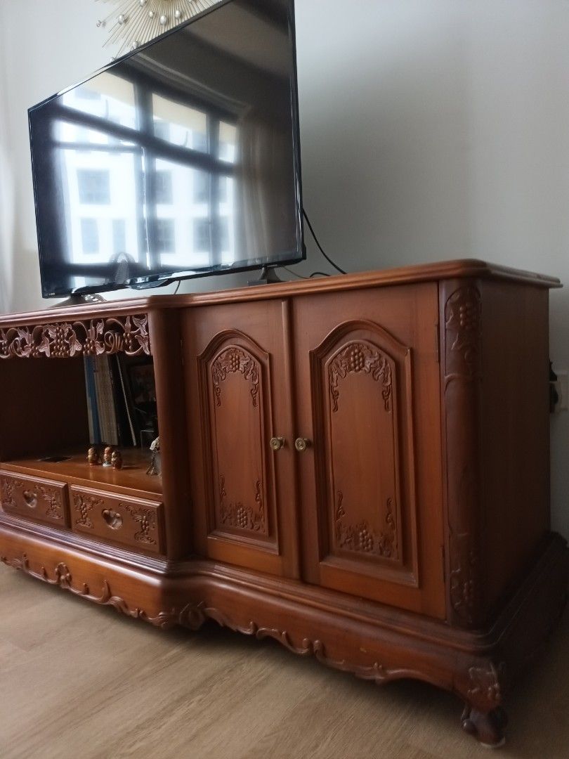 Solid Teak console (Category: TV Consoles) located in Singapore. Submitted by adamzzzzz (Listing ID 1445855732, Image 2). Description: - Solid teak wood console - Large size (over 1.2m) - Features intricate carvings and detailed craftsmanship - Offers ample storage with cabinets and drawers - Warm, rich wood tone - Available for meetup at Sengkang.