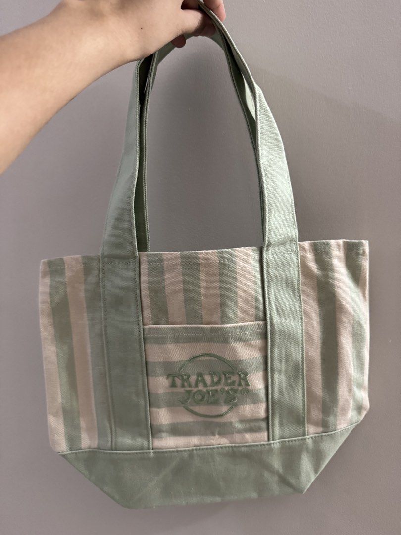 Trader Joe's Striped Mini Canvas Tote Bag (Category: Tote Bags) located in San Pablo. Submitted by simplicitybeaute (Listing ID 1445973753, Image 2). Description: - Cute mini tote bag from Trader Joe's - Classic green and cream stripe pattern - Convenient small front pocket - Internal pockets for organization - Ideal for quick errands or carrying daily essentials - Brand new, still has the original tag attached.