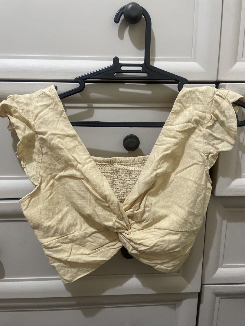 Twisted Front Smocked Crop Top with Flutter Sleeves (Category: Others Tops) located in Makati City. Submitted by thingsoncelovedph (Listing ID 1445947832, Image 1). Description: - Adorable yellow crop top - Features a stylish twisted front detail - Comfortable smocked bodice - Charming flutter sleeves - Versatile: pairs perfectly with high-waisted jeans or skirts - Easy to dress up or down - Made with breathable fabric.