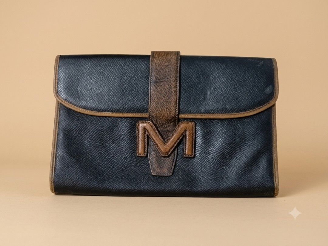 Authentic Morabito Paris "M" Logo Business Clutch (Category: Belt bags, Clutches and Pouches) located in Quezon City. Submitted by lem1998 (Listing ID 1445970628, Image 1). Description: Description: Elevate your accessory collection with this authentic vintage piece from the prestigious French luxury house, Morabito Paris. This sophisticated business bag, featured in the brand's "M logo" line, is a testament to the refined craftsmanship Morabito 