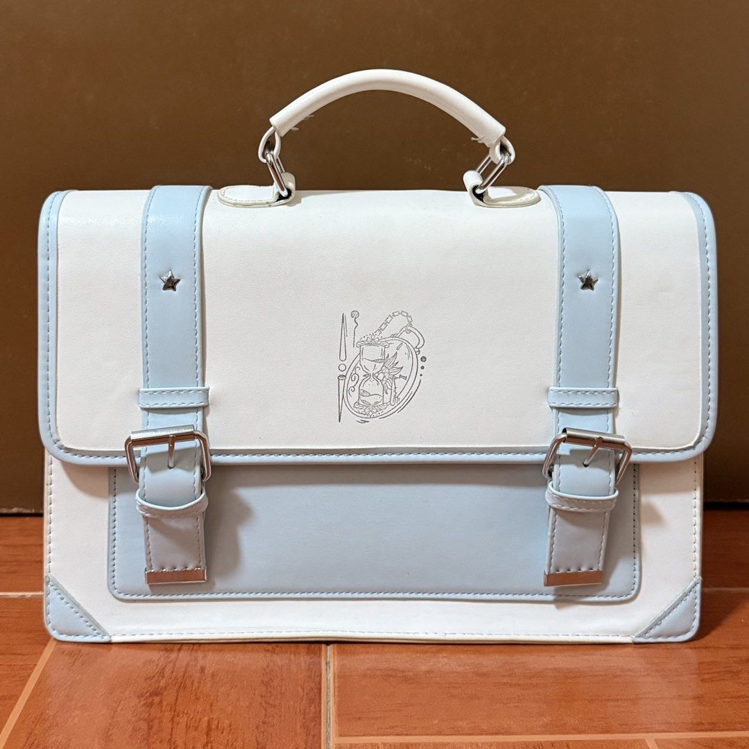 White and Light Blue Satchel Bag (Category: Luxury Bags & Wallets) located in Marikina City. Submitted by moniescart (Listing ID 1445966178, Image 1). Description: MOP: Gcash - Used only a few times - Minor flaw: yellowing of some thread due to age - Can be used as either a shoulder bag or a backpack - Both straps are still in good condition - Has a small pocket inside - Lock magnet - See images for measurements .