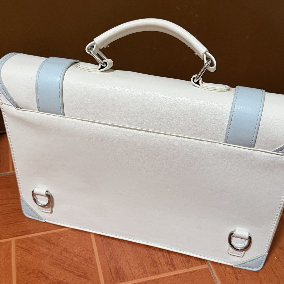 White and Light Blue Satchel Bag (Category: Luxury Bags & Wallets) located in Marikina City. Submitted by moniescart (Listing ID 1445966178, Image 3). Description: MOP: Gcash - Used only a few times - Minor flaw: yellowing of some thread due to age - Can be used as either a shoulder bag or a backpack - Both straps are still in good condition - Has a small pocket inside - Lock magnet - See images for measurements .