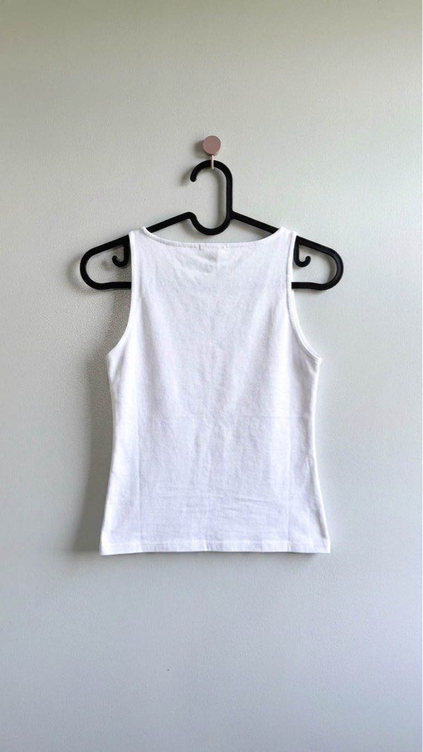 White Ribbed Tank Top (Category: Sleeveless) located in Paranaque City. Submitted by ownbynikki (Listing ID 1445864165, Image 1). Description: - Basic white ribbed tank top.