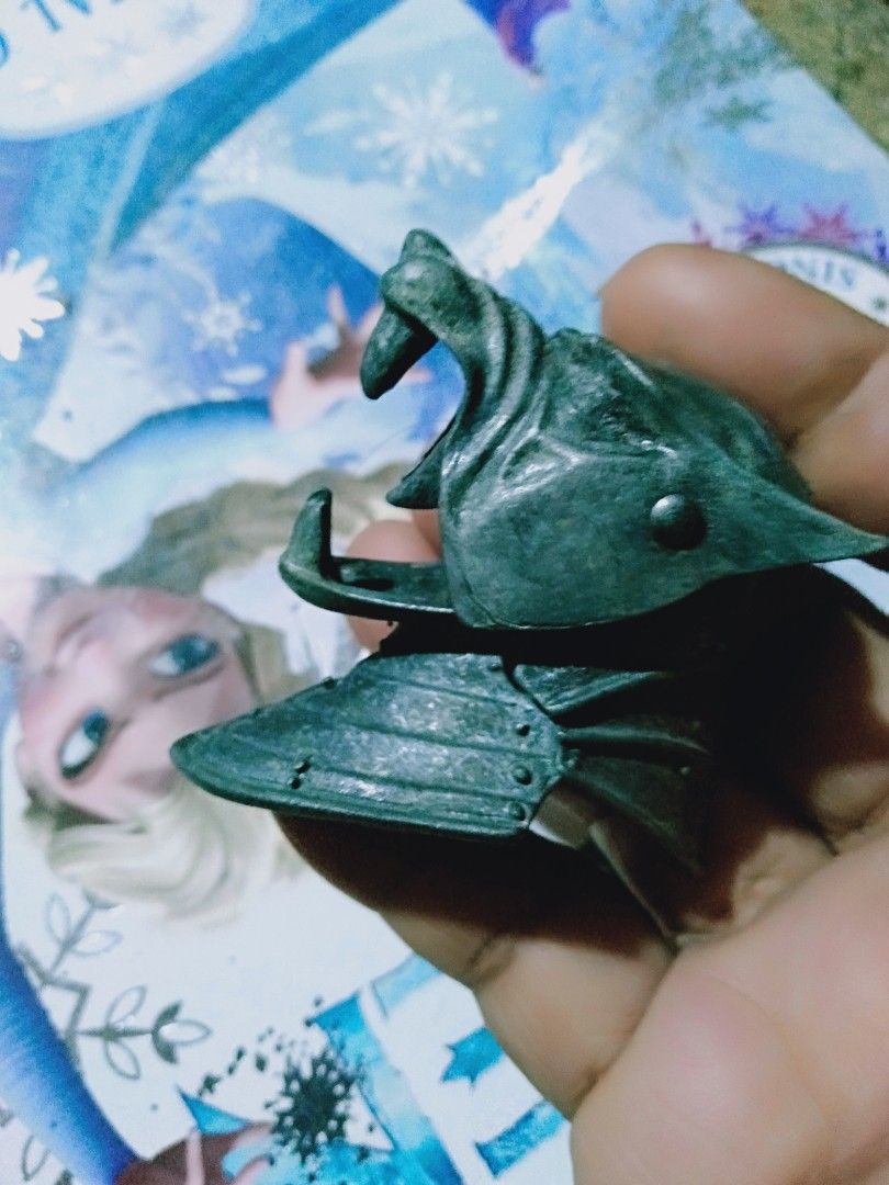 Wolf Head Armor Accessory for Action Figure (Category: Figurines & Statues) located in Davao. Submitted by bravemoon_556cd5 (Listing ID 1445894375, Image 2). Description: - Unique wolf head armor piece, perfect for action figures. - Dark metallic green finish. - Shows some signs of wear and tear, adding character. - Ideal for customizing action figures or replacing lost parts. - A great collectible item for enthusiasts..