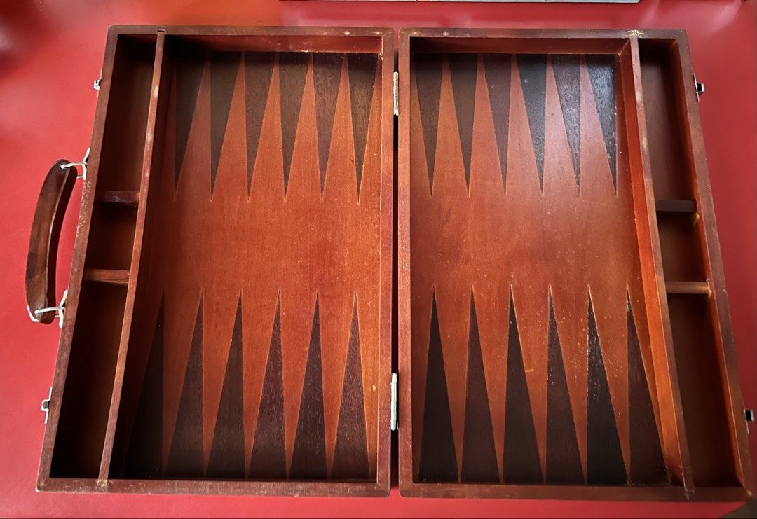 Wooden Backgammon Board Game with Checkers and Dice (Category: Board Games & Puzzles) located in Las Pinas. Submitted by rjmwings (Listing ID 1445842719, Image 2). Description: Vintage Wooden backgammon set. Bought in 1999 Includes checkers in black and light wood colors. Also comes with two dice. The board folds for easy storage and portability: Size 15” wide, 10” length Great for game nights with family and friends. For collectors of vintage bo