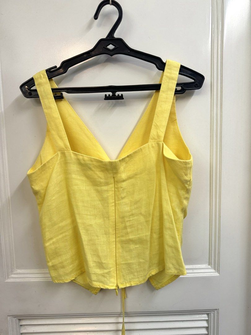 Yellow Linen Ruched V-Neck Crop Top (Category: Blouses) located in Manila. Submitted by mae-v (Listing ID 1445946761, Image 3). Description: - Yellow crop top from Anything Else - Features a ruched front with drawstring tie, adjustable - V-neckline and sleeveless design - Zipper at the back - Versatile for casual or dressed-up looks - Linen - from Bangkok.