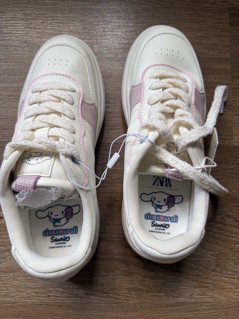 Kids White Sneakers (Category: Sneakers) located in Cainta. Submitted by declutterwithme_476 (Listing ID 1445808469, Image 2). Description: - Adorable white sneakers with charming pink accents. - Features a cute Cinnamoroll graphic on the side. - Playful prints on the back of the shoes. - Soles have a subtle pinkish hue. - Comes with original tags, ensuring authenticity. - Size: 37 (Philippine sizing). - Perfect for fans of Cinnamoroll and cute f
