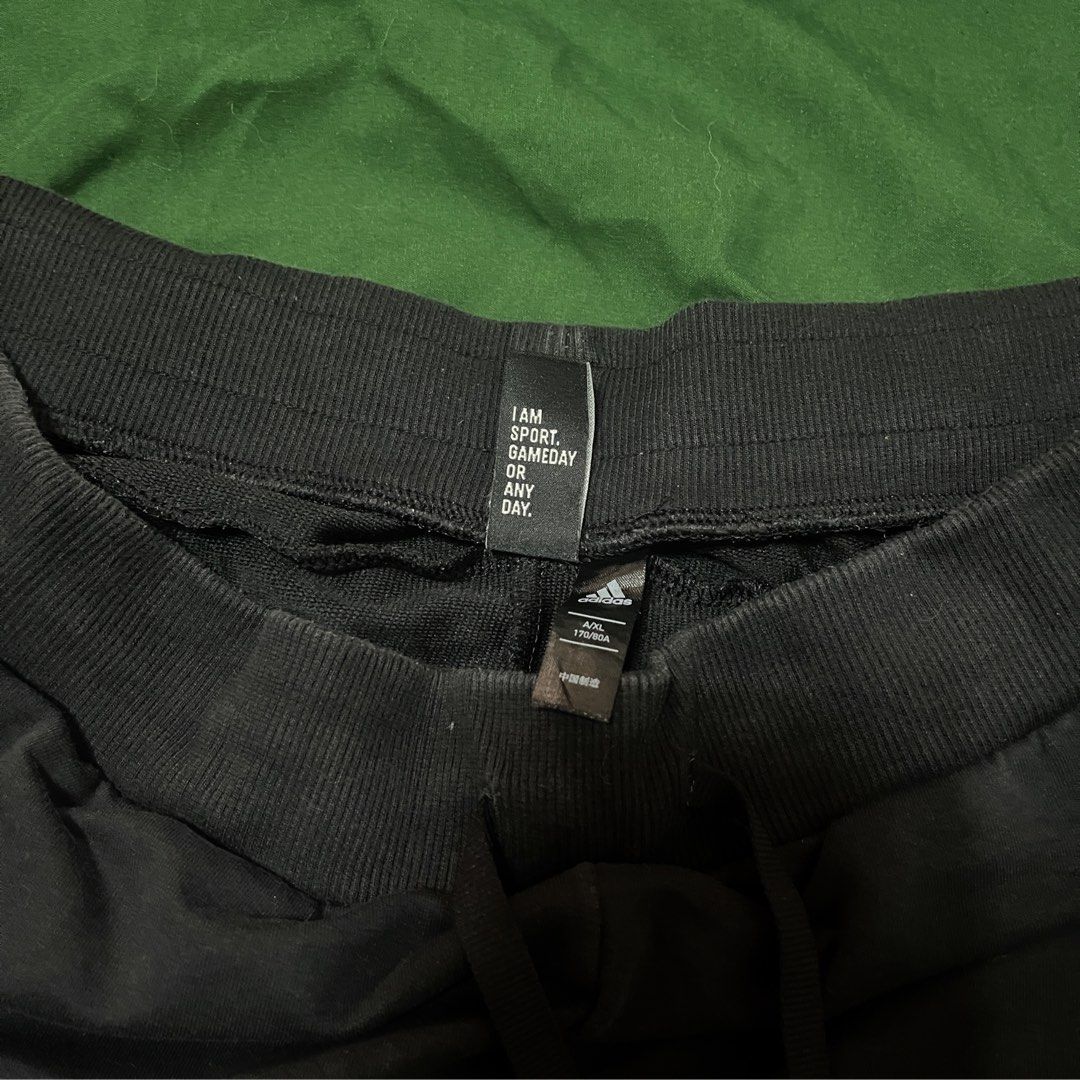 Adidas Black Joggers with White Stripes (Category: Other Bottoms) located in Manila. Submitted by vmnnts (Listing ID 1446040037, Image 3). Description: - Size XL on tag best fir Large - Iconic white three stripes down the sides - Drawstring waist - Adidas logo on the left leg - Ideal for casual wear or workouts - Color rate 8/10 RFS: Decluttering.