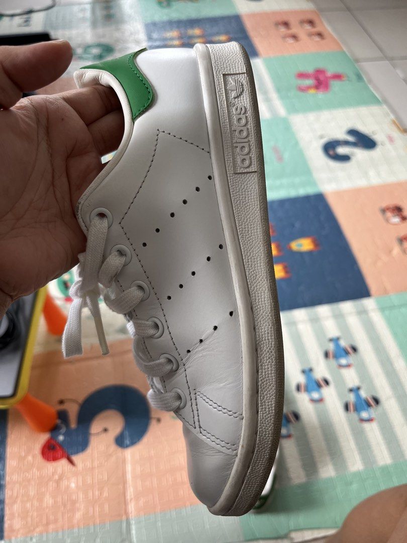 Adidas Stan Smith White Green Leather Sneakers (Category: Sneakers) located in Makati City. Submitted by caeannesee (Listing ID 1446161795, Image 2). Description: - Classic white Adidas Stan Smith sneakers - Iconic green heel tab - Perforated 3-Stripes - Genuine leather upper - White laces - Soles show some wear - Ideal for everyday wear SF shouldered by BUYER good as new barely used .