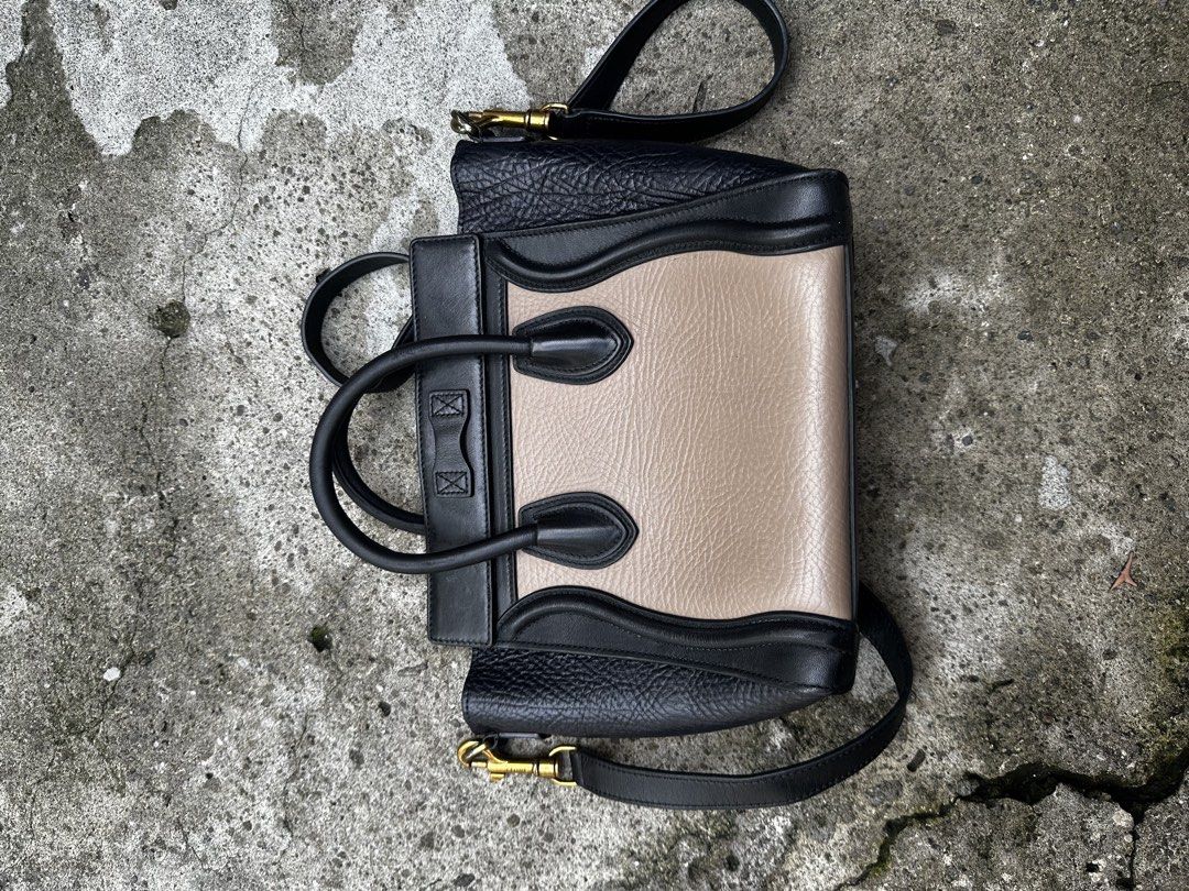 AUTHENTIC Celine Nano Luggage Tote Bag (Category: Luxury Bags & Wallets) located in Quezon City. Submitted by la.deals (Listing ID 1446118544, Image 2). Description: Celine Nano Luggage tote bag. Two-tone design with black and beige leather. Has top handles and a detachable shoulder strap. Zipper closure on the front pocket and main compartment. Made in Italy. Shows some signs of wear on the zipper pull and interior..