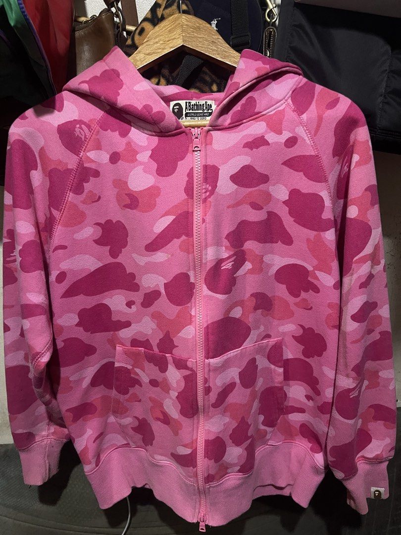 BAPE Pink Camo Full Zip Hoodie (Category: Hoodies) located in Mandaluyong City. Submitted by mark2pac (Listing ID 1446108111, Image 1). Description: - Classic BAPE pink camo hoodie - Full zip closure - Two front pockets - Comfortable and stylish - Perfect for any streetwear collection - A true staple piece.