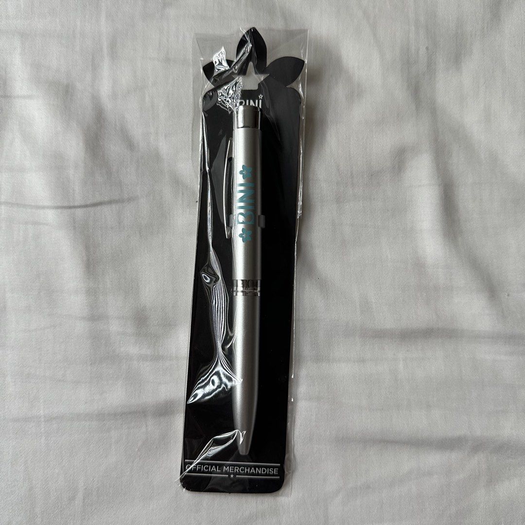 BINI Official Merchandise Pen (Category: Stationery & School Supplies) located in Caloocan City. Submitted by preloveditemsbyyana (Listing ID 1446061195, Image 1). Description: - Official DINI merchandise pen - Silver-toned metal body - Teal lettering - Comes in original packaging - Ideal for collectors, everyday use, or as a gift.