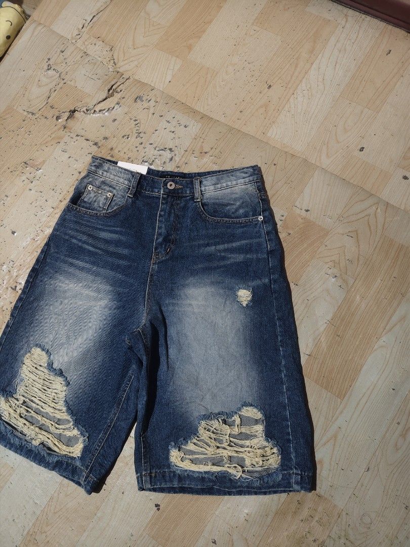 Blue Distressed Ripped Denim Shorts (Category: Shorts) located in Davao. Submitted by thriftforus (Listing ID 1446068361, Image 2). Description: - Cool blue denim shorts - Ripped details on the front -Waist 28-30 length 24 thigh 14 - Mid-thigh length - Button and zip closure - Front and back pockets - Ideal for casual wear.