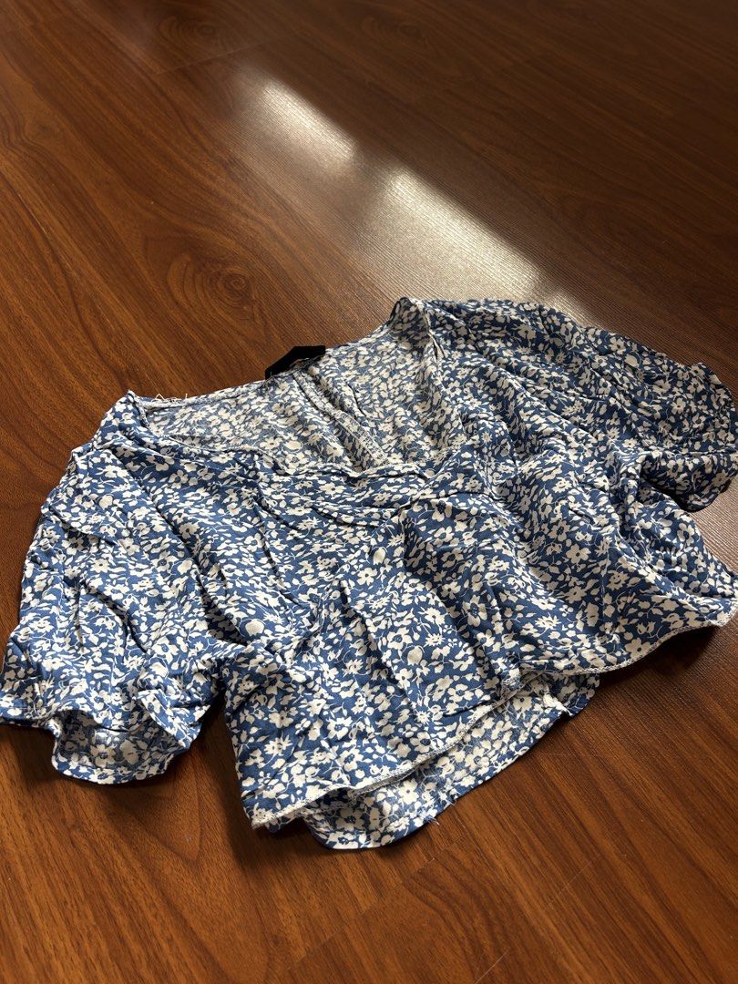 Blue Floral Wrap Crop Top with Tie (Category: Blouses) located in Quezon City. Submitted by sdnncmp (Listing ID 1446052767, Image 2). Description: - size S on tag, fits XS also - Wrap style with tie closure - Lightweight fabric, perfect for beach!! dm for any inquiries or questions!.