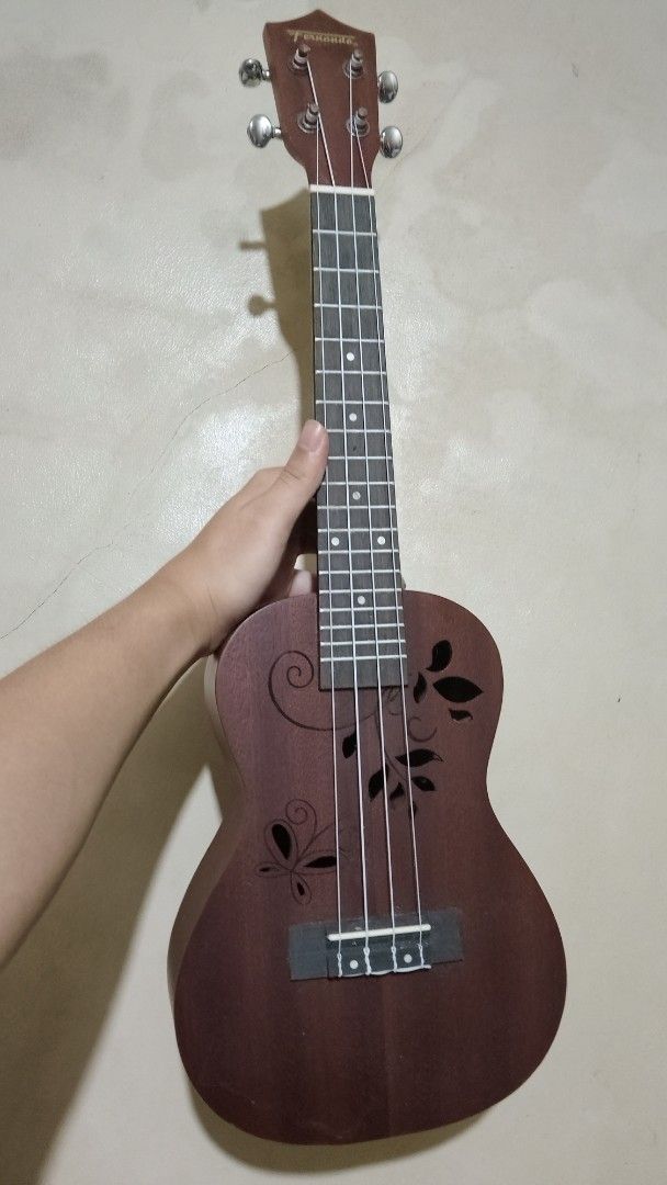 Brown Ukulele with Floral Cutouts (Category: Musical Instruments) located in Mandaluyong City. Submitted by chalmerzzz (Listing ID 1445994680, Image 2). Description: Selling my pre-loved Fernando Ukulele for only 1,800 pesos feel free to chat for negotiations -brown with floral cutouts very cute issues: may signs of usage: gasgas.