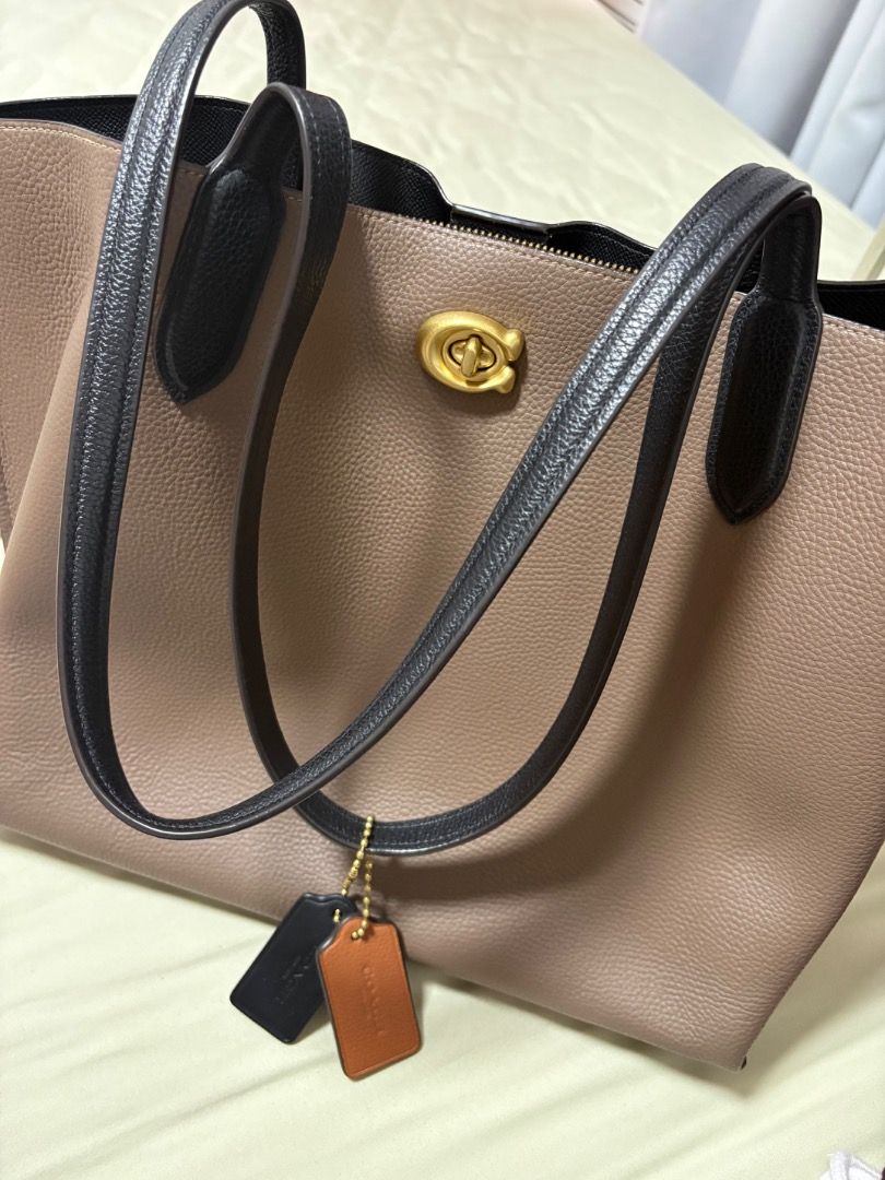 Coach Tote Bag Pebbled Leather Reversible (Category: Luxury Bags & Wallets) located in Quezon City. Submitted by 4strid.wind (Listing ID 1446005928, Image 2). Description: - Authentic Coach tote bag in taupe pebbled leather 💯 - With dust bag, paper bag, and papers 🛍️ - Black interior - Minor issue in the magnetic closure (see photo) - Gold hardware details - Includes two leather hang tags - Zippered compartment inside - Spacious for essentials 