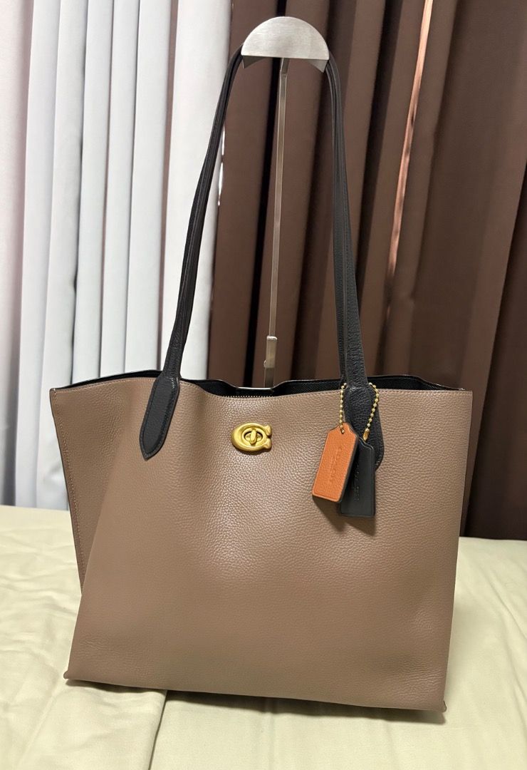 Coach Tote Bag Pebbled Leather Reversible (Category: Luxury Bags & Wallets) located in Quezon City. Submitted by 4strid.wind (Listing ID 1446005928, Image 1). Description: - Authentic Coach tote bag in taupe pebbled leather 💯 - With dust bag, paper bag, and papers 🛍️ - Black interior - Minor issue in the magnetic closure (see photo) - Gold hardware details - Includes two leather hang tags - Zippered compartment inside - Spacious for essentials 