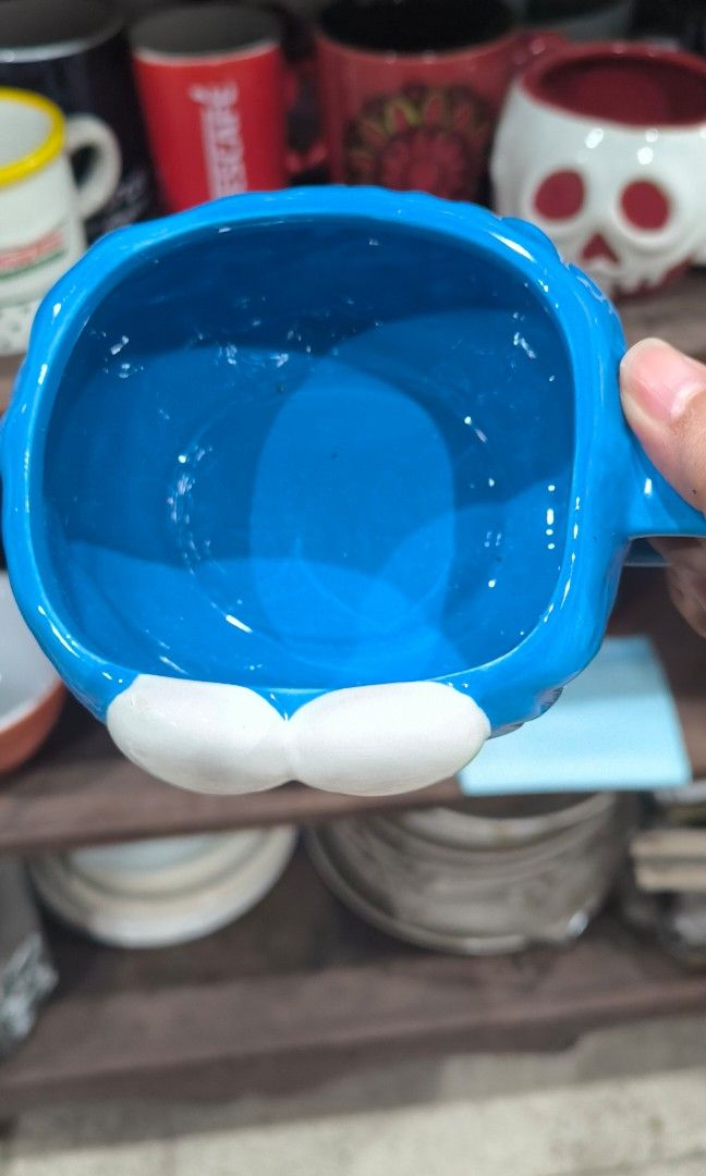Cookie Monster Ceramic Mug (Category: Coffee & Tea Tableware) located in Cainta. Submitted by cookietherapyph (Listing ID 1446135602, Image 2). Description: Cookie Monster Mug -No black in eyes but i think thats how it is designed bec i've seen an Elmo one too Minor issues (See last 2 pics): -Small chip in handle -Rough surface in top right eye but not noticeable at all RFS: Decluttering MOP: Gcash/Maribank LOC: Cainta, Rizal SHIPPING: J&T or Lal