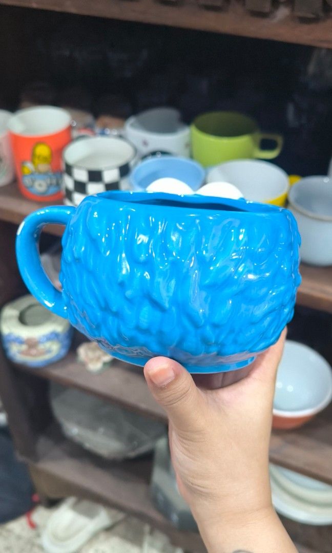 Cookie Monster Ceramic Mug (Category: Coffee & Tea Tableware) located in Cainta. Submitted by cookietherapyph (Listing ID 1446135602, Image 3). Description: Cookie Monster Mug -No black in eyes but i think thats how it is designed bec i've seen an Elmo one too Minor issues (See last 2 pics): -Small chip in handle -Rough surface in top right eye but not noticeable at all RFS: Decluttering MOP: Gcash/Maribank LOC: Cainta, Rizal SHIPPING: J&T or Lal