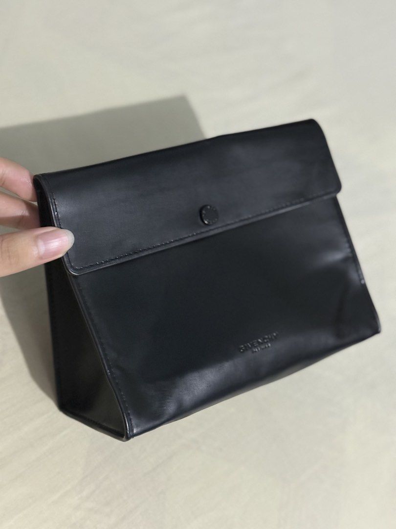 Givenchy Black Leather Pouch (Category: Luxury Bags & Wallets) located in Quezon City. Submitted by marcothegreat1992 (Listing ID 1446080635, Image 1). Description: - Genuine Givenchy black leather pouch - Sleek and simple design - Secure button closure on front flap - Ideal for organizing essentials or as a standalone clutch.