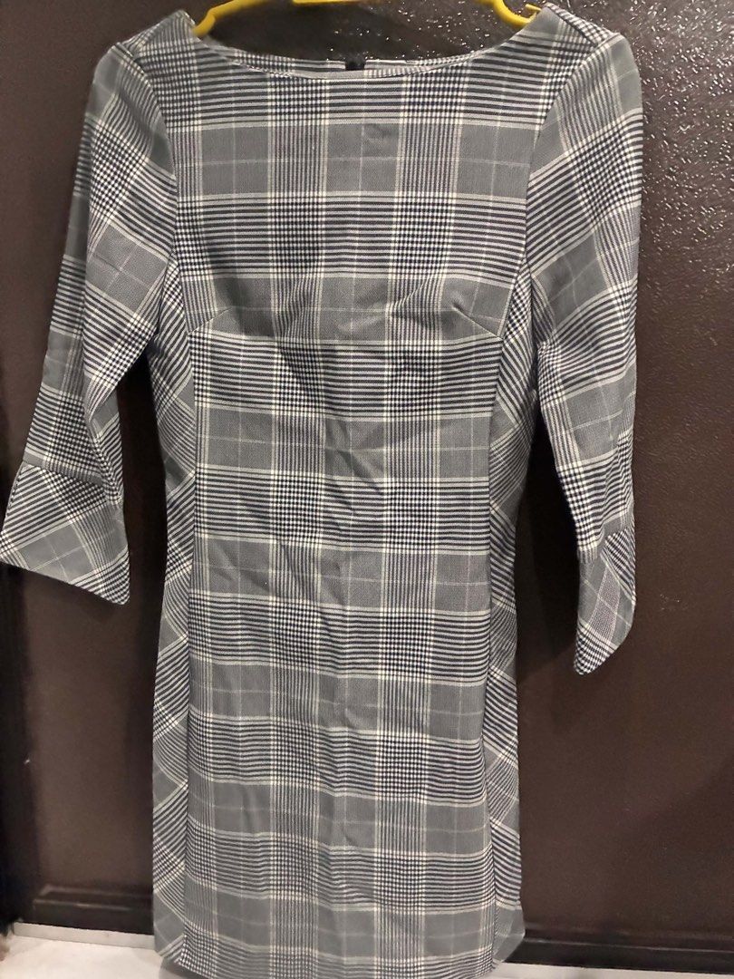 Grey Plaid 3/4 Sleeve Dress (Category: Dresses) located in Quezon City. Submitted by mnqfinds (Listing ID 1446112697, Image 1). Description: - Classic grey plaid pattern - Flattering cut - 3/4 sleeves with a slight flare - Convenient back zipper closure - Versatile for work or casual outings.