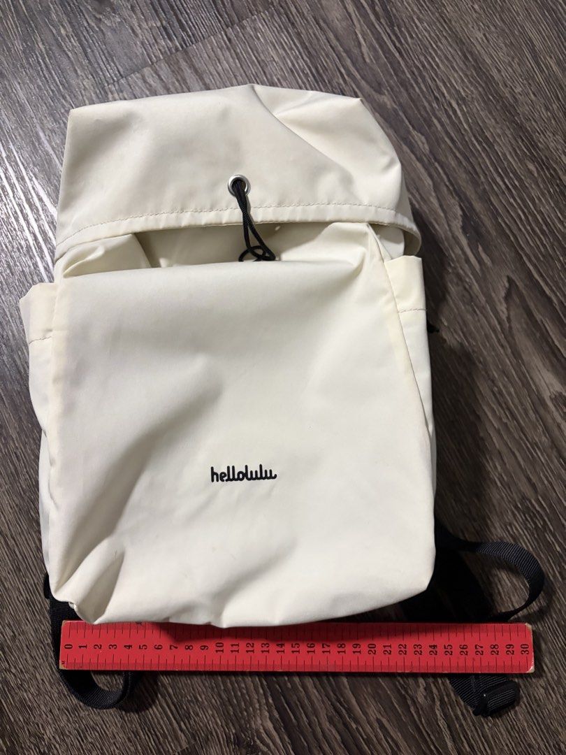 hellolulu Cream Drawstring Backpack (Category: Backpacks) located in Singapore. Submitted by newcat714 (Listing ID 1446033887, Image 1). Description: - Brand: hellolulu - Color: Cream - Closure: Drawstring top - Exterior: Side pockets - Interior: Multiple compartments - Size: Approx. 30cm (H) x 25cm (W) - Ideal for: Daily essentials.