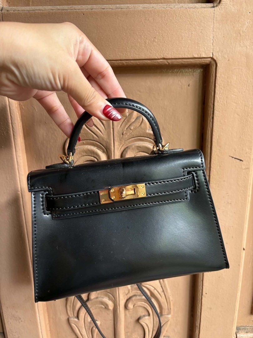 Hermes Kelly Mini Black Leather Gold Hardware (Category: Luxury Bags & Wallets) located in Manila. Submitted by graciouslygraceee (Listing ID 1445995974, Image 2). Description: - Classic black mini Kelly bag - Made in France - Elegant gold hardware details - Includes both top handle and shoulder strap - Perfect for dressing up or down - A timeless addition to your collection - Please check photos for detailed condition.