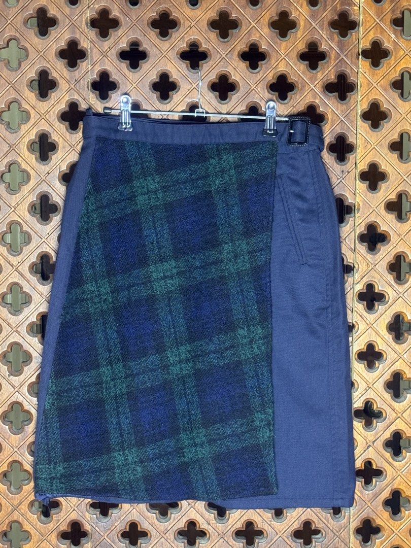 Initial N°2 Navy Blue Plaid Wrap Skirt with Adjustable Belt (Category: Skirts) located in Quezon City. Submitted by EveryWANTShop (Listing ID 1446093780, Image 1). Description: - Navy blue wrap skirt - Contrasting plaid front panel - Adjustable buckle belt - Two back pockets - Estimated size: 155/62A - Versatile for casual and smart casual looks.