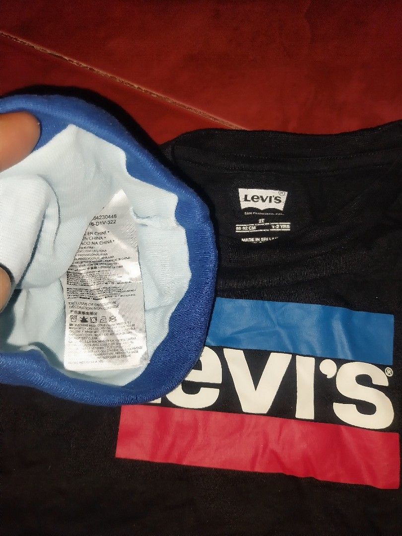 Levi's T-shirt and beanie Set (Category: Babies & Kids Fashion) located in Polangui. Submitted by rodjean0814-25739 (Listing ID 1446102991, Image 2). Description: - Classic Levi's black t-shirt with iconic red, white, and blue logo graphic. - Comes with matching blue and white beanie - Ideal for comfortable and stylish casual wear. - Both items feature the authentic Levi's tag. -500+sf.