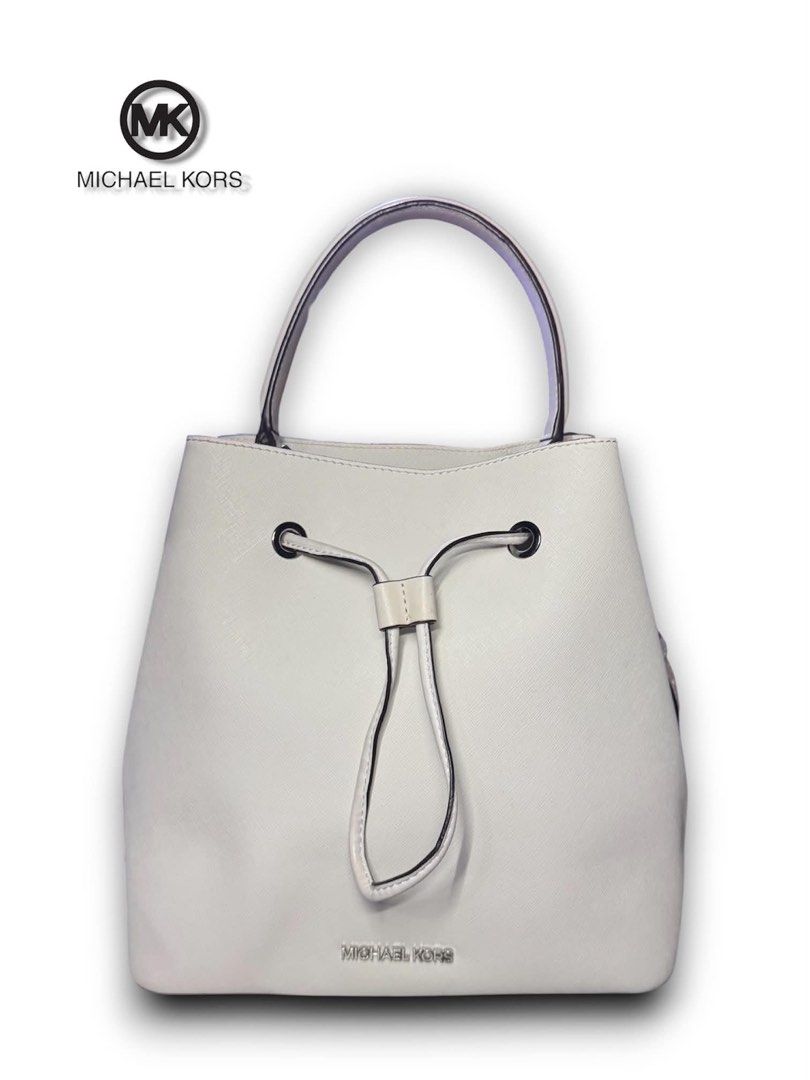 Michael Kors White Leather Bucket Bag (Category: Luxury Bags & Wallets) located in Cebu City. Submitted by gabgaaab (Listing ID 1446100766, Image 3). Description: - Michael Kors Suri Small Saffiano Leather Bucket Bag - Excellent Condition - Style: Bucket bag with a drawstring closure - Color: Off-white / Cream - Hardware: Silver-tone hardware - Interior: Open main compartment with a side slip pocket - Dm me for inquiries.