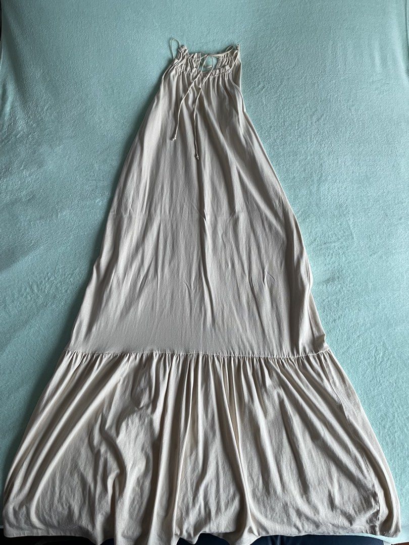 MNG Beige Ruched Tie Strap Maxi Dress (Category: Dresses) located in Manila. Submitted by kokokrunchtoh (Listing ID 1446073172, Image 1). Description: - MNG beige maxi dress - Ruched bodice with tie straps - Tiered, flowy skirt design - Ideal for casual outings or beach days - Comfortable and stylish.