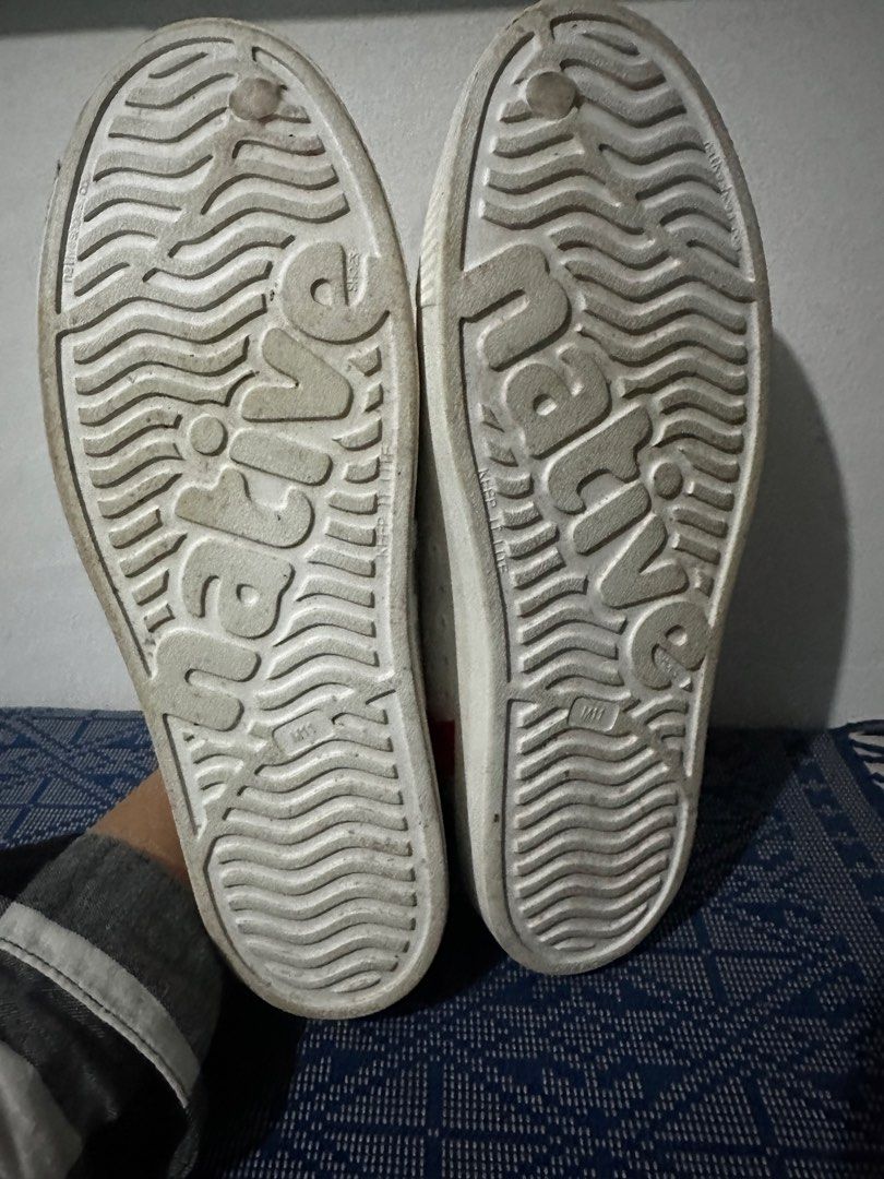Native Shoes White Perforated Slip-On Sneakers (Category: Sneakers) located in Davao. Submitted by relovedpicks (Listing ID 1446124242, Image 3). Description: - White Native shoes - Breathable perforated design - Red and blue stripe detail on heel - Easy slip-on style - Perfect for casual wear or water activities - Soles show some wear, but plenty of life remaining -condition 9.8/10 .