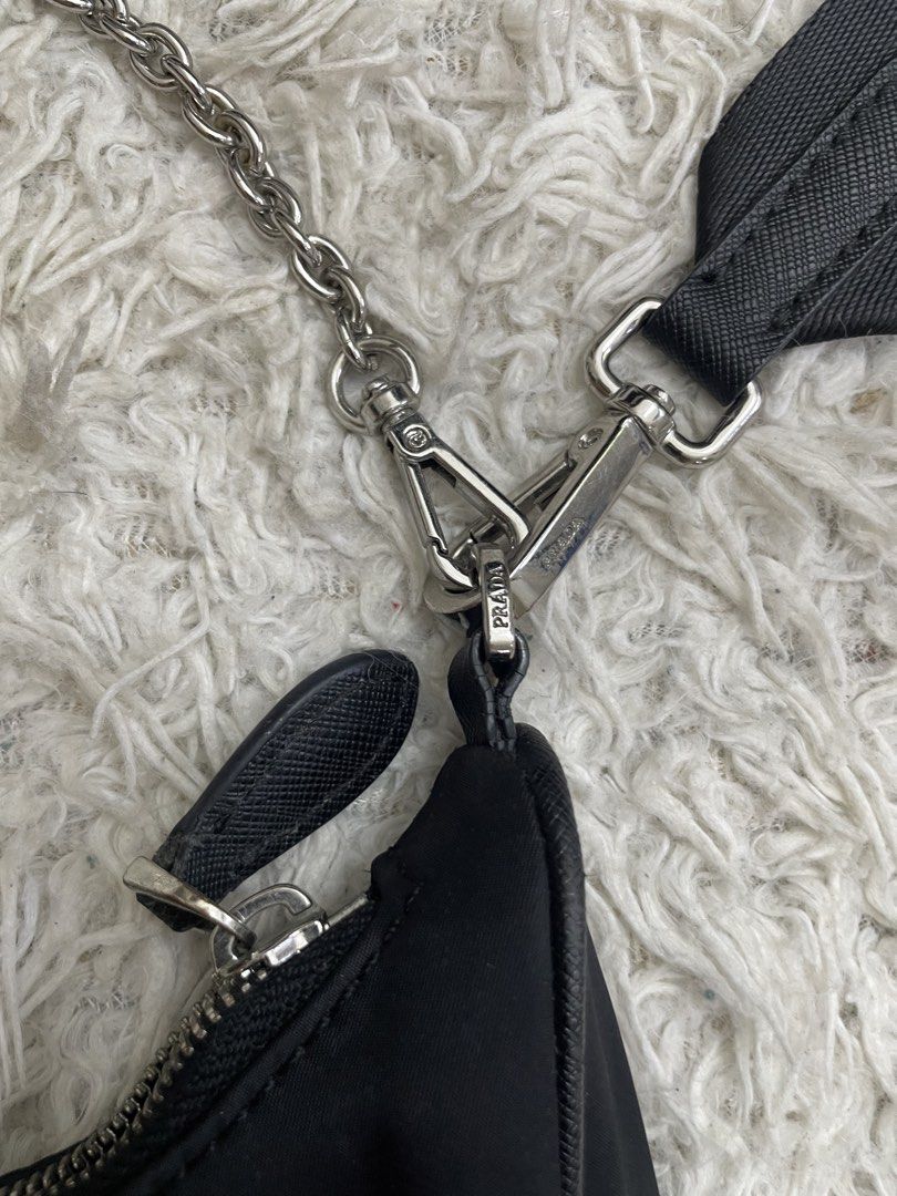 Prada Nylon Shoulder Bag (Category: Luxury Bags & Wallets) located in Quezon City. Submitted by impulse.ph (Listing ID 1446072806, Image 3). Description: - Authentic Prada shoulder bag - Made in Italy - Durable nylon material - Silver chain strap - Adjustable fabric strap with Prada logo - Secure zipper closure - Authenticity tag included inside.