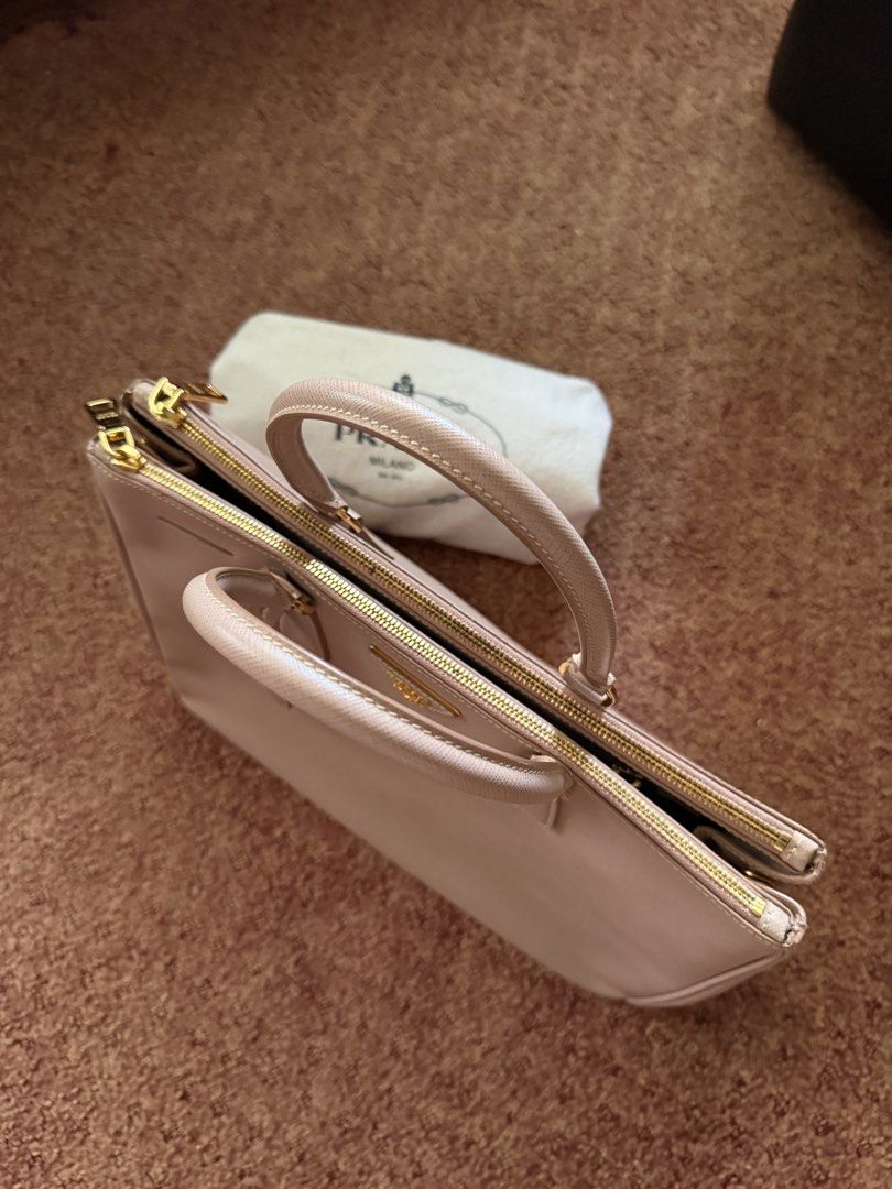 Prada Saffiano Lux Tote Bag (Category: Luxury Bags & Wallets) located in Bulacan. Submitted by rc_retailing (Listing ID 1446007351, Image 3). Description: - Authentic Prada Saffiano Lux Tote - Color: Light Pink - Hardware: Gold - Includes: Dust Bag - Features: Spacious interior, smooth zippers - Versatile: Ideal for daily use or special occasions - Classic Prada design.